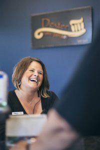 The Dexter Family Dentistry receptionist smiling at patients