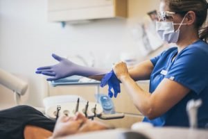Dentists Pulling On Latex Gloves