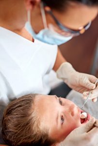 young girl having a dental cleaning