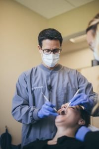 young woman at the dentist in chair having teeth checked