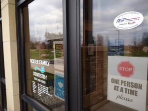 Door to Dexter Family Dentistry with Signage and Hours Information