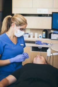 Dentist explaining process for dental crowns to patients