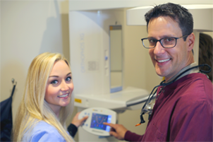 Dentist Standing with Hygienist